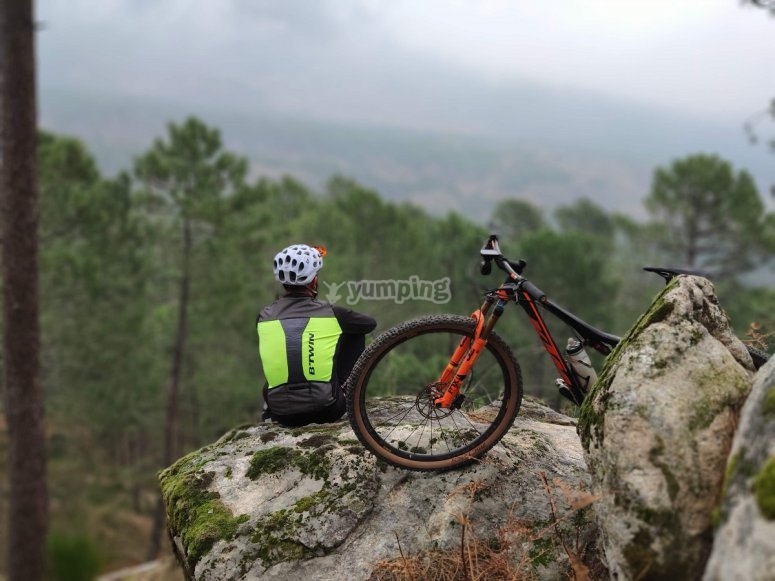 En lo alto de la roca junto a la mountain bike