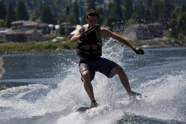 Niño en traje de neopreno negro haciendo esquí acuático en el río Camel