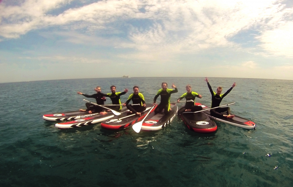 grupo chicos divirtiendose haciendo paddle board