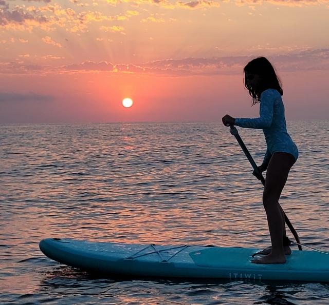Haciendo paddle board al amanecer