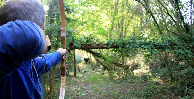  disparando con un arco en el bosque