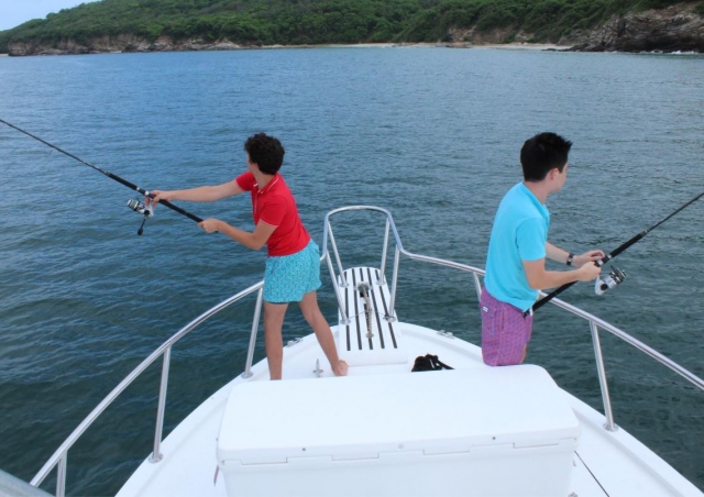  Young people fishing on the boat 