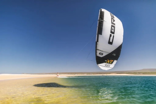 La gran cometa de Kitesurf desplegada en la playa